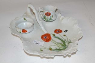 A Limoges porcelain dish with small bowl and jug, all painted with poppies (Inventory 306)
