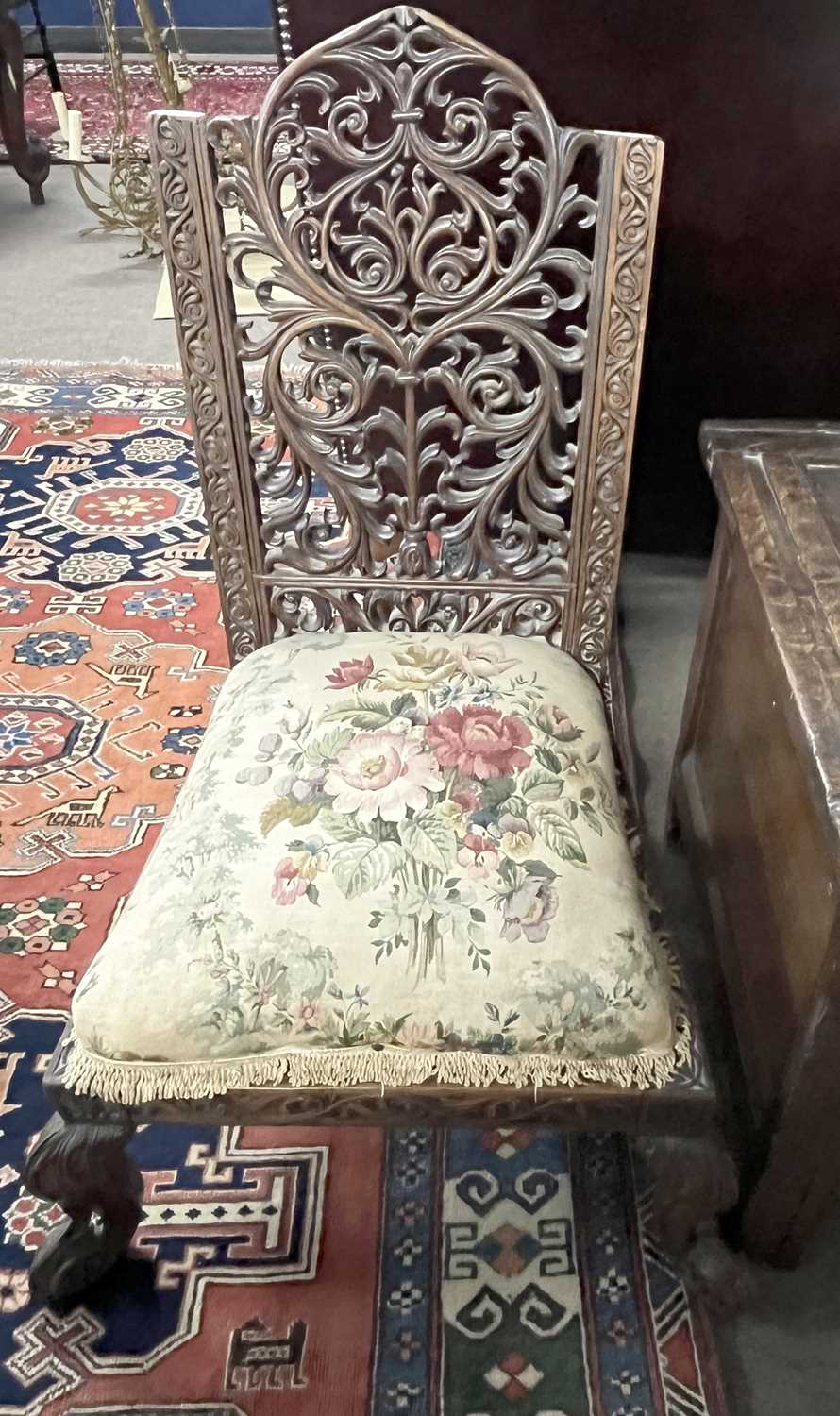 A 19th Century Far Eastern hardwood side chair with pierced back, carved scrolled front feet and a