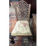 A 19th Century Far Eastern hardwood side chair with pierced back, carved scrolled front feet and a