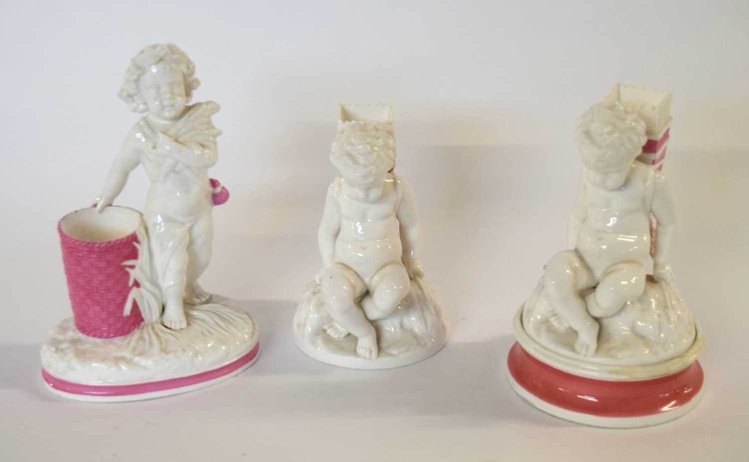 A group of three 19th Century white glazed spill vases, modelled as cherubs, one on a pink - Image 2 of 2