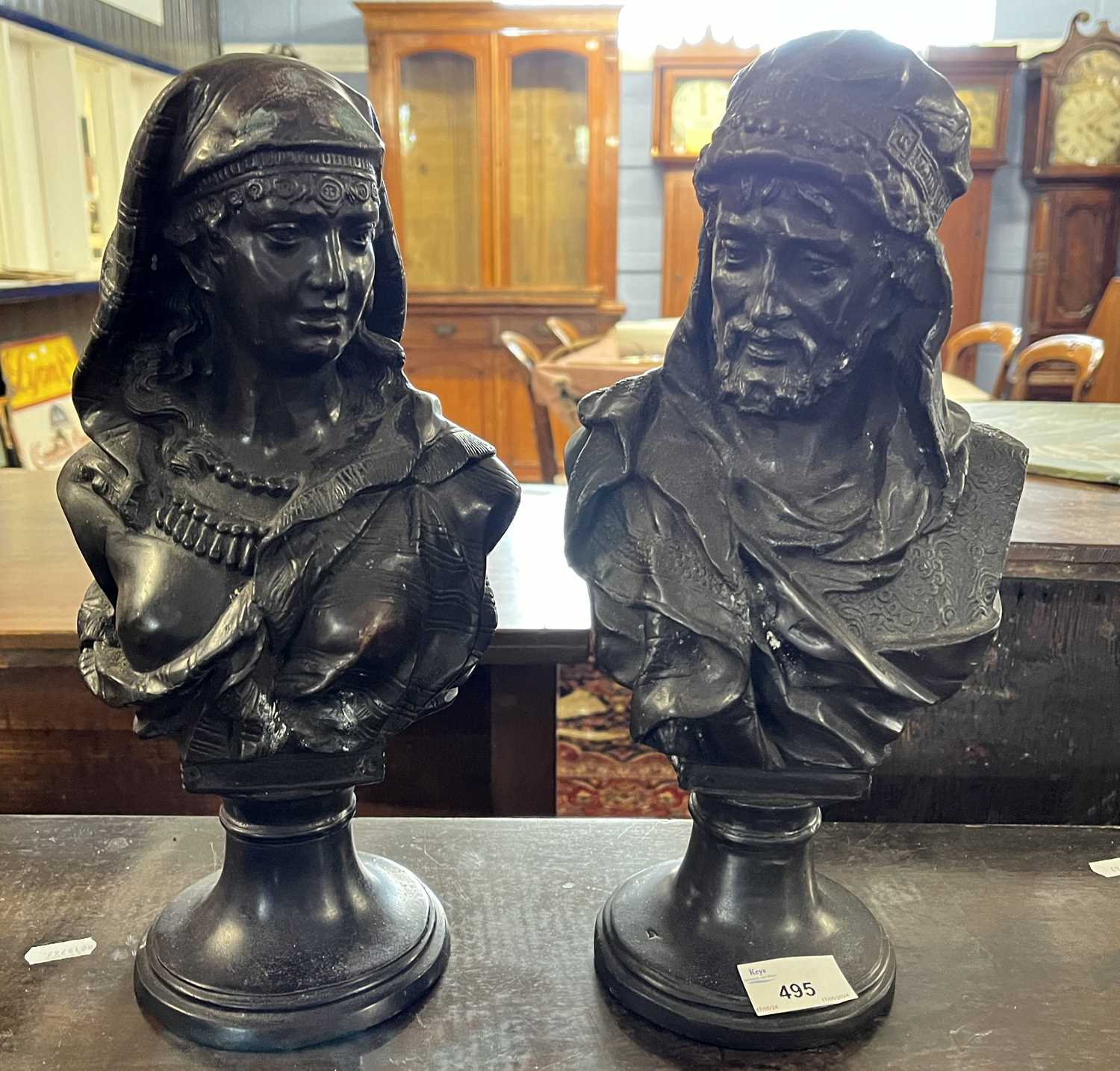 After Buese a pair of small bronzed metal busts of a Middle Eastern lady and gent, the gent signed