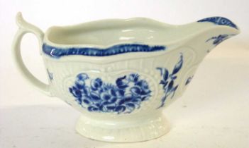 An 18th Century Worcester porcelain sauce boat, the ribbed body decorated with panels of flowers
