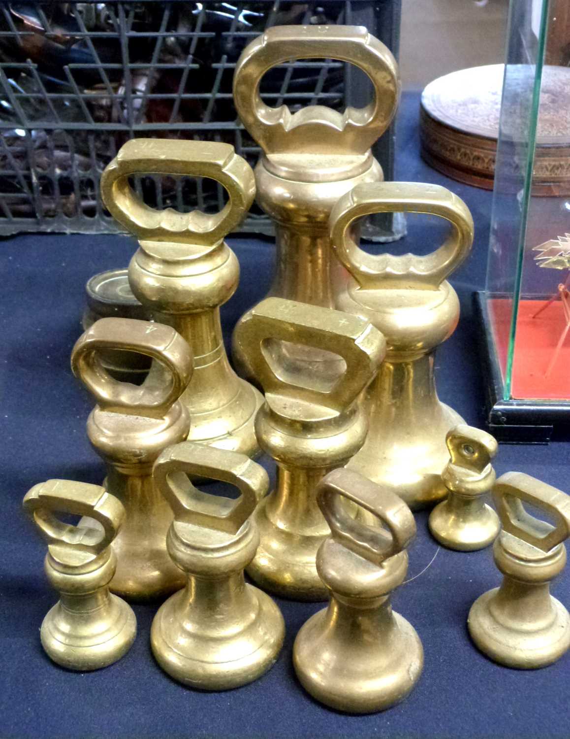 A group of brass butchers bell weights and others, largest 14lb