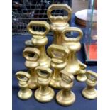 A group of brass butchers bell weights and others, largest 14lb