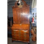 A large 18th Century American bureau bookcase, the top section with swept broken arch pediment