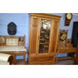 A Victorian ash and inlaid bedroom suite comprising a mirrored door wardrobe, a dressing table