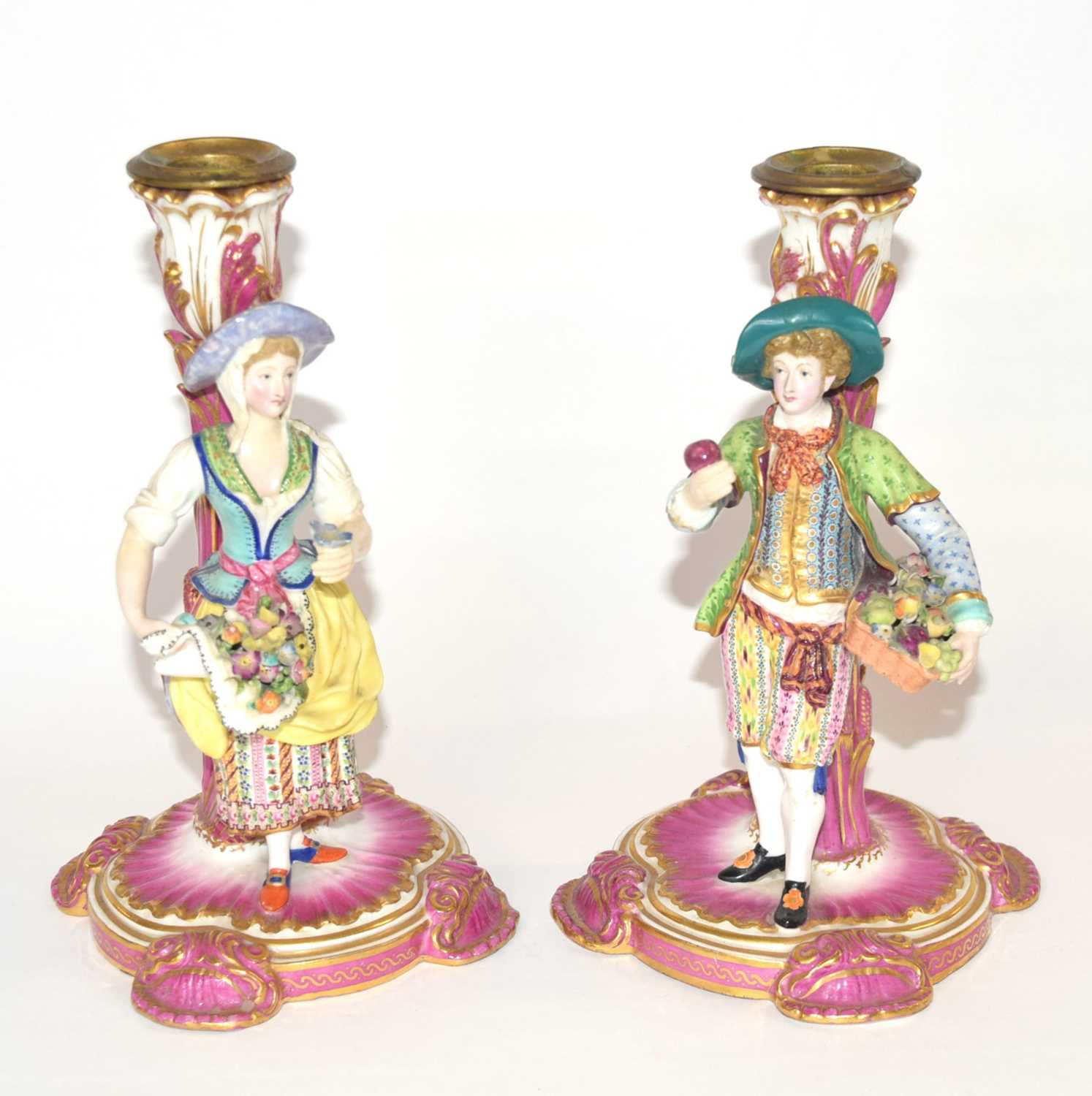 Pair of continental porcelain Minton style candlesticks modelled as fruit and flower sellers, 24cm
