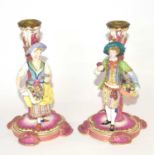 Pair of continental porcelain Minton style candlesticks modelled as fruit and flower sellers, 24cm