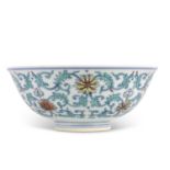 A Chinese Wucai bowl with flowerheads amongst scrolling foliage Apocryphal Qianlong mark to base