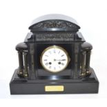 A Victorian slate clock with white enamel dial with Roman numerals