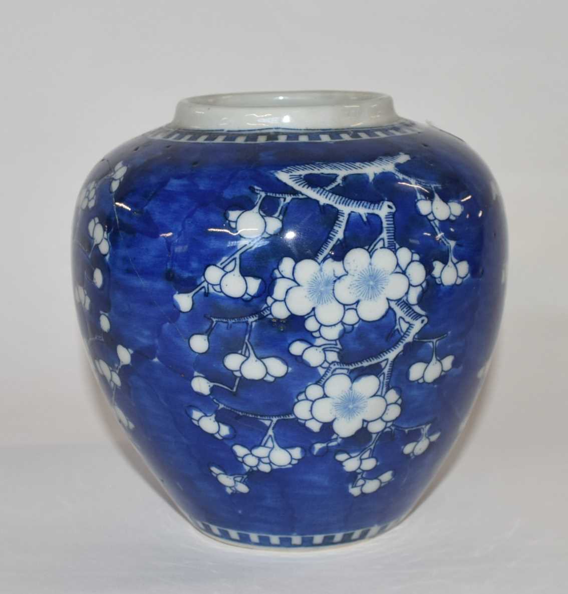 Chinese porcelain ginger jar 19th Century decorated with prunus on a blue ground