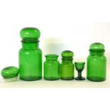 Group of green glass jars and a small eye bath