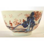 A Lowestoft tea bowl decorated with the dolls house pattern (chip to rim)