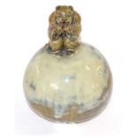 An unusual carved Chinese pottery vase of globular shape with a Chinese boy as finial