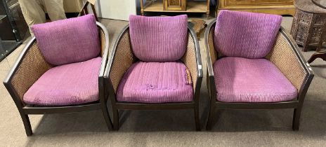 A set of three early 20th Century bergere bow back tub chairs with sprung seats