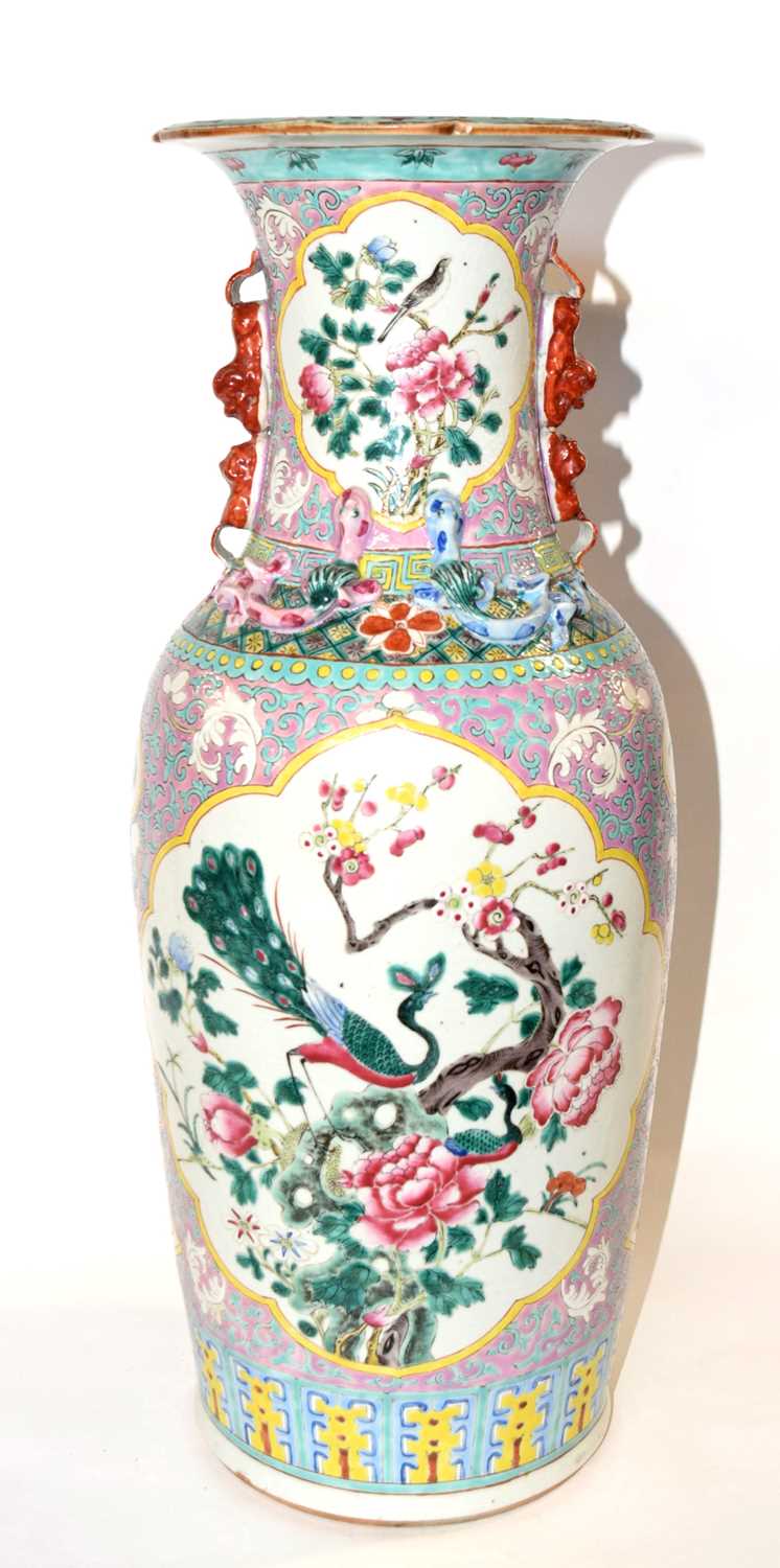 An impressive Chinese porcelain vase decorated in famille rose/vert with peacocks amongst foliage