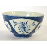 A Worcester porcelain tea bowl, the blue ground with fan type reserve panels of flowers