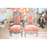 A pair of large 19th Century gothic style throne type chairs with elaborately carved backs and arms,