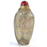 Antique Chinese reverse-painted snuff bottle with hardstone stopper and decorated with intricate