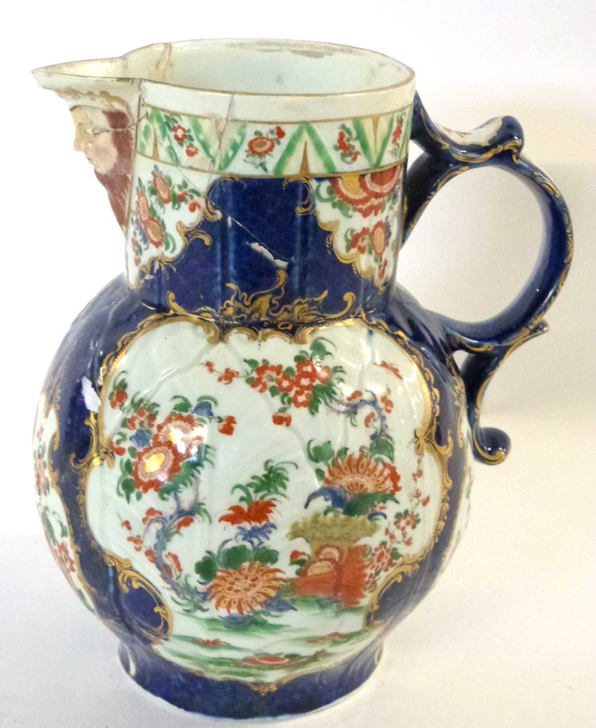 An 18th Century Worcester mask jug with blue ground with panels of Kakiemon style decoration (broken - Image 3 of 6
