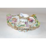 A 19th Century porcelain candle holder painted with floral sprays and flowers in relief