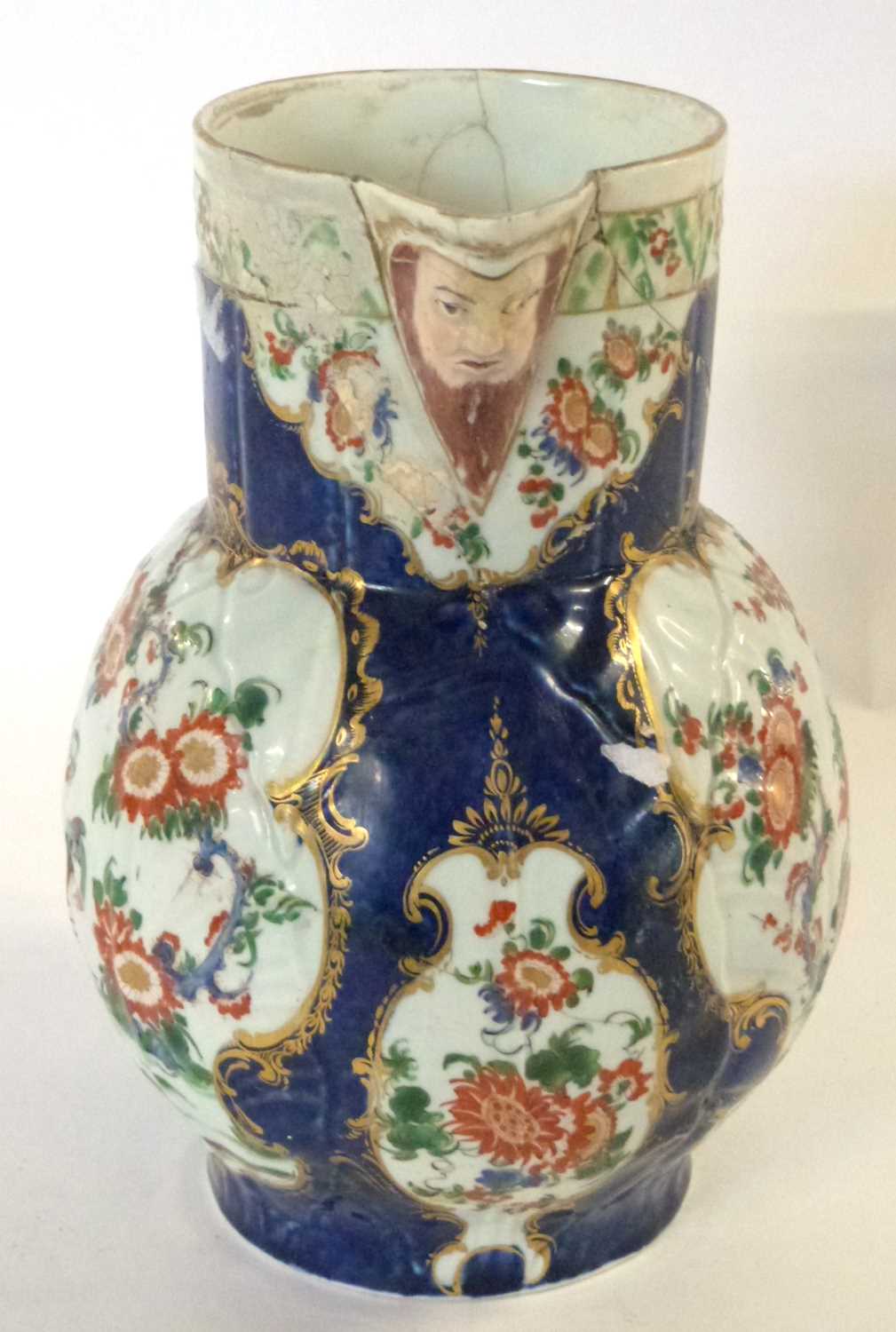 An 18th Century Worcester mask jug with blue ground with panels of Kakiemon style decoration (broken - Image 2 of 6