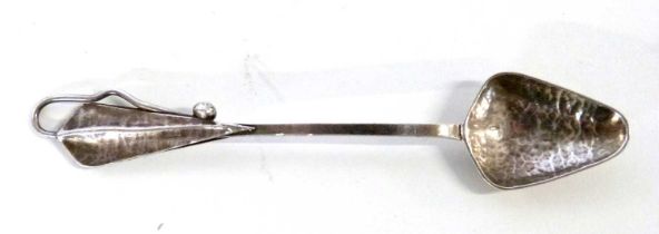 An Art Nouveau (silver) white metal spoon with planished finish to bowl and decorative leaf