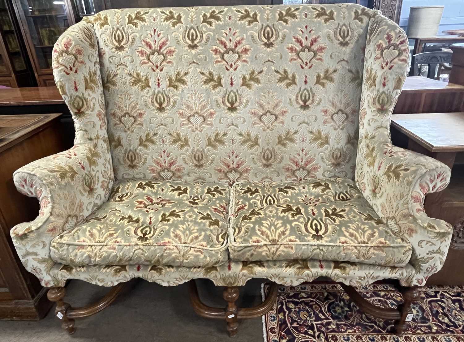 A Carolean style wing back sofa with floral upholstery and turned legs united by two X formed - Image 2 of 6