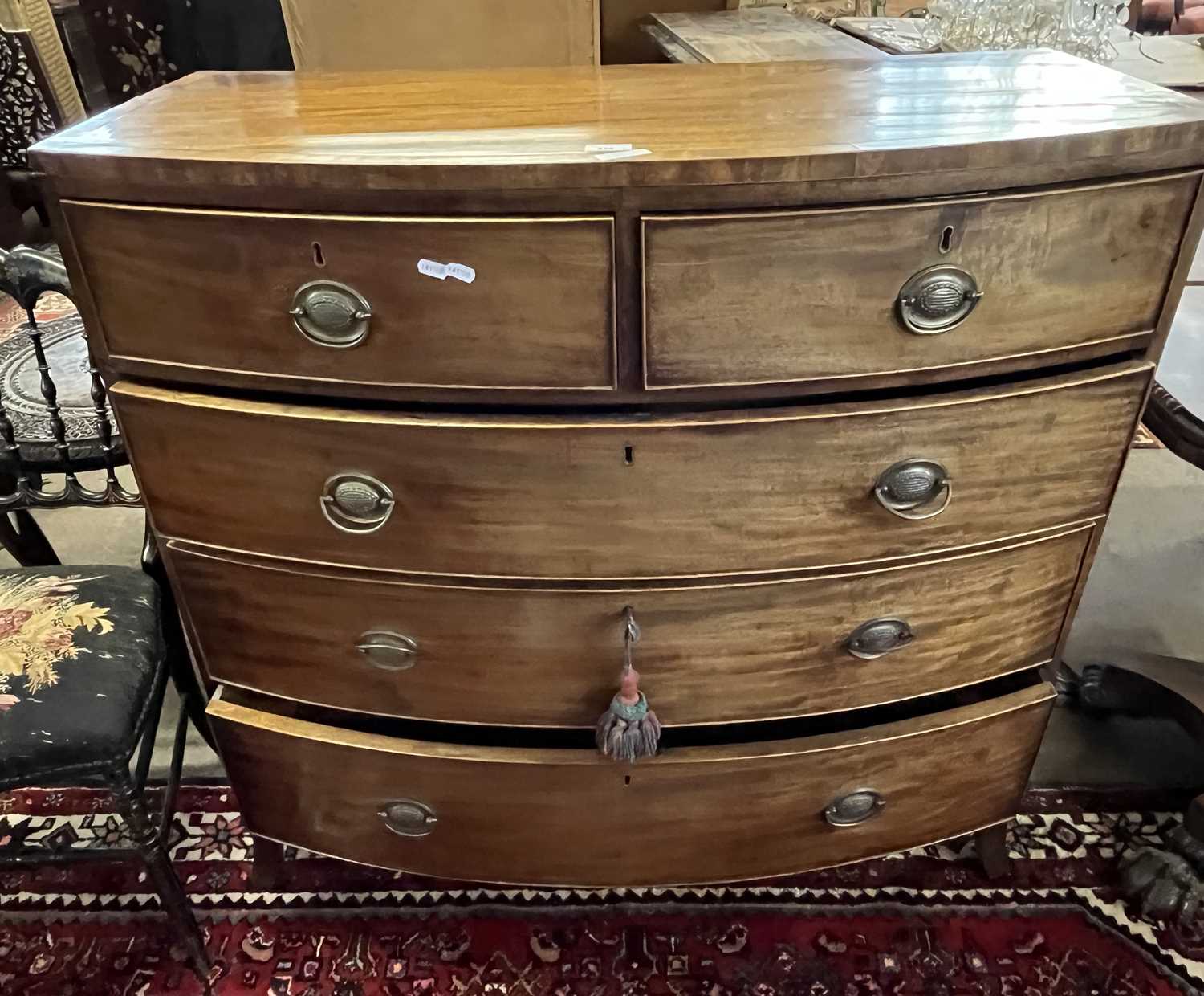 A late Georgian mahogany bow front five drawer chest with oval handles and outswept legs, 107cm