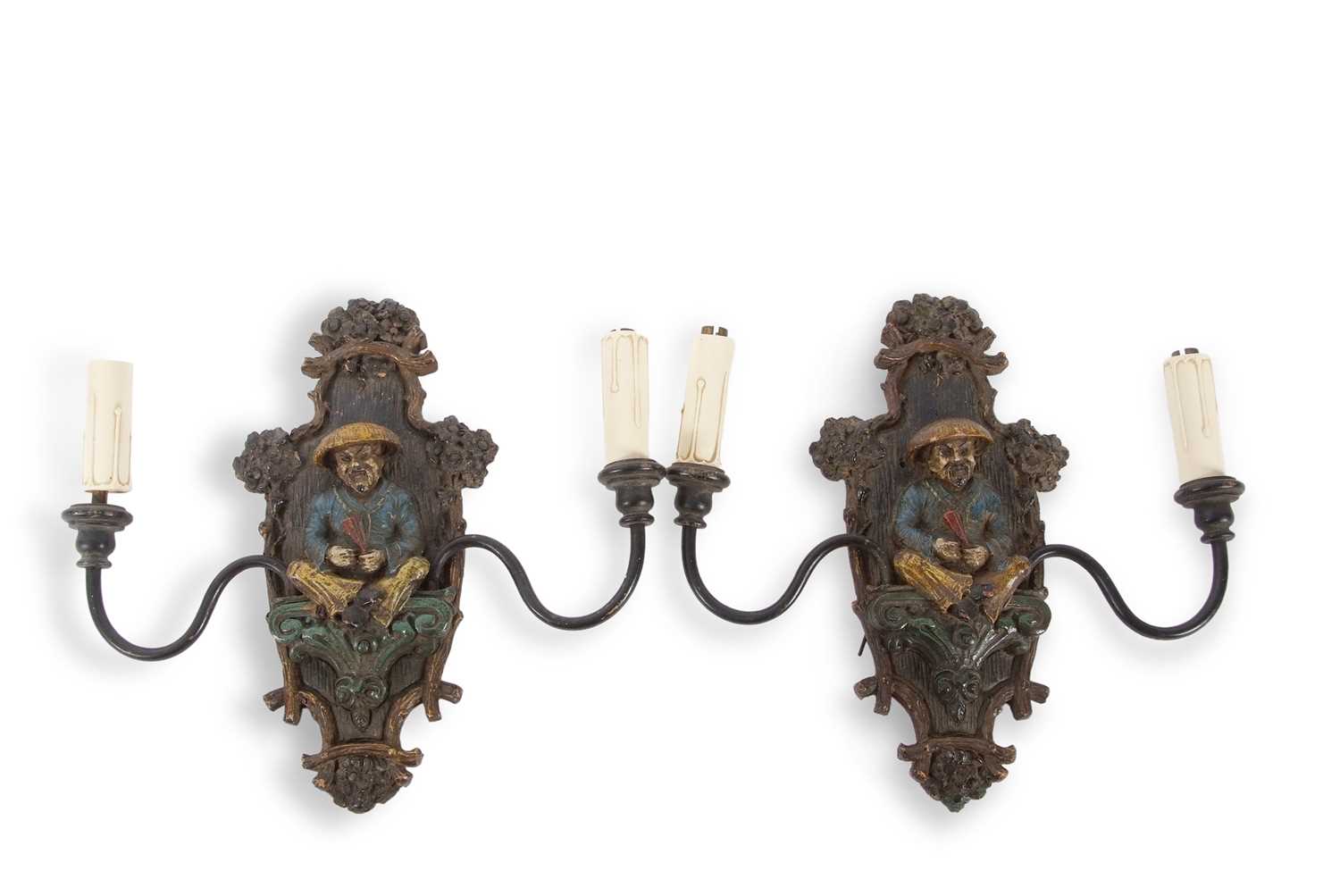 A pair of early 20th Century wall lights with central polychrome panel decorated with a Chinese