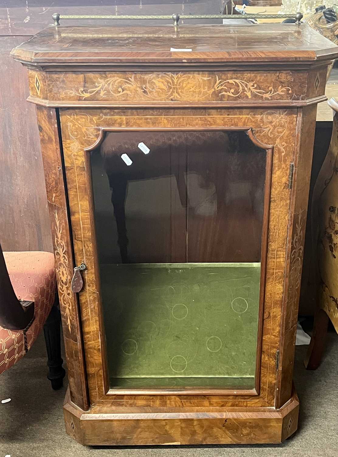 A Victorian walnut veneered pier cabinet with inlaid decoration and glazed door