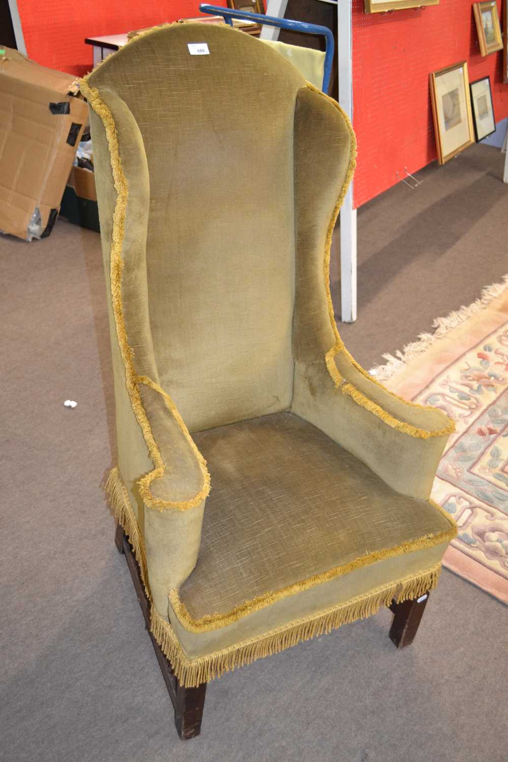 A narrow Georgian style wing back armchair, 118cm high