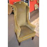 A narrow Georgian style wing back armchair, 118cm high