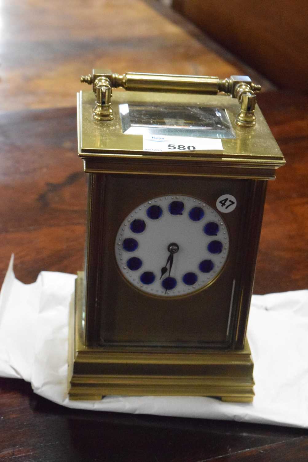 Late 19th or early 20th Century brass cased carriage clock with white and blue enamel dial with