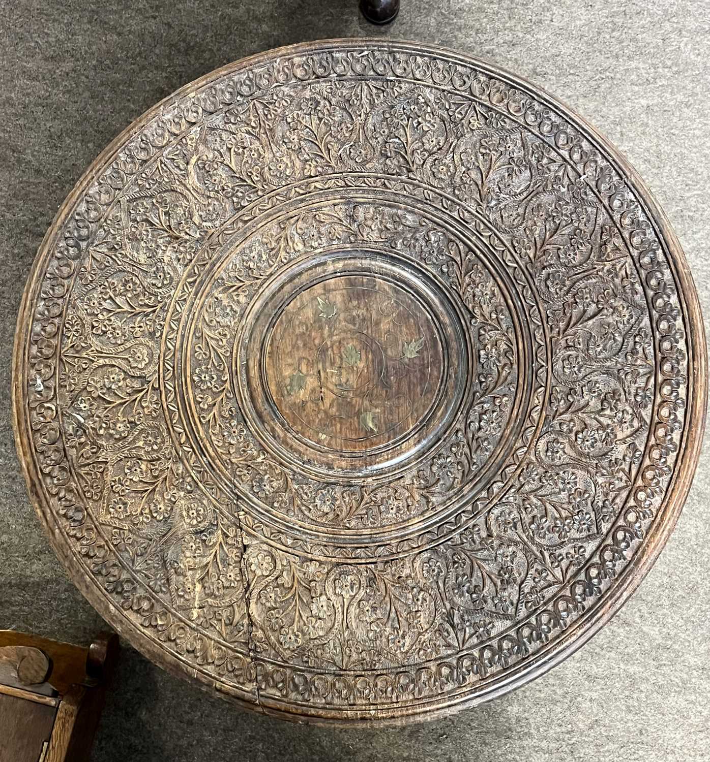 An Indian hardwood occasional table with carved circular top and pierced folding base, top 45cm - Image 2 of 3