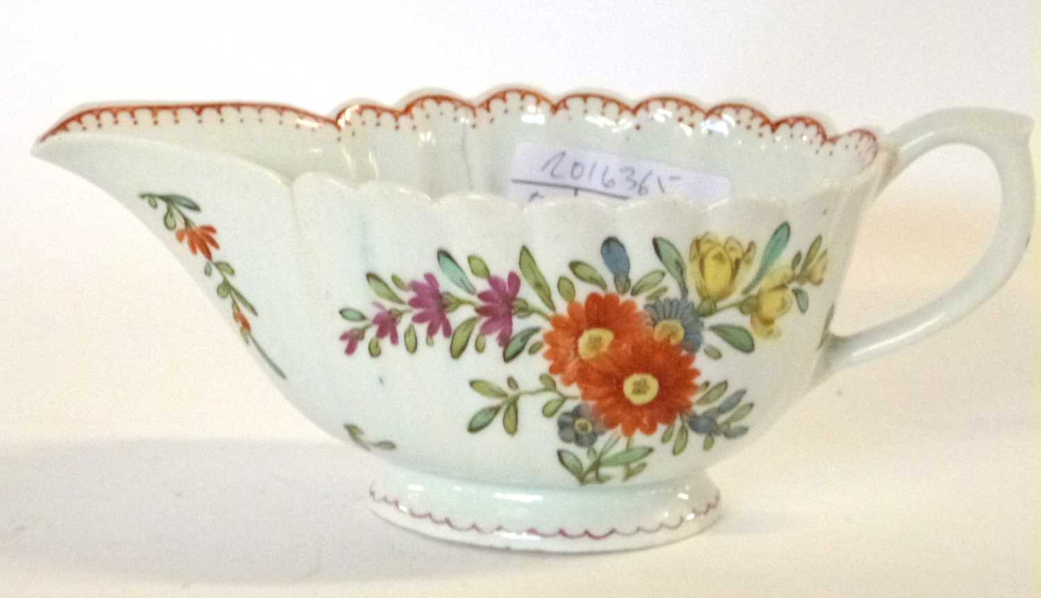 An 18th Century Bow porcelain sauce boat of ribbed form with floral decoration (hairline), 18cm - Image 2 of 3