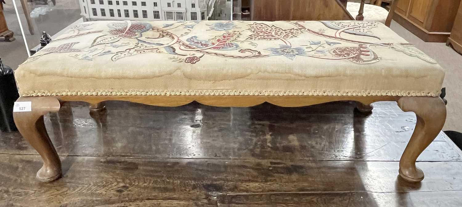 An early 20th Century rectangular footstool in the Georgian style with a floral needlework covering,