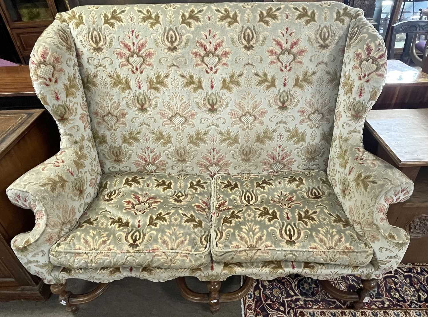 A Carolean style wing back sofa with floral upholstery and turned legs united by two X formed - Image 5 of 6
