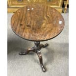 A Georgian mahogany wine table with circular single plank top, turned column and tripod base, top