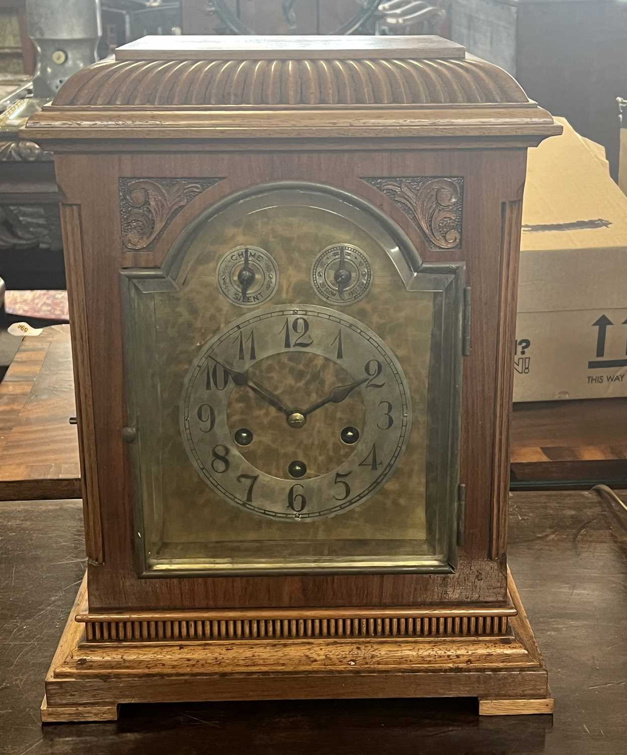 Early 20th Century mantel clock by Jung Hans with arched brass and silver dial, three train brass