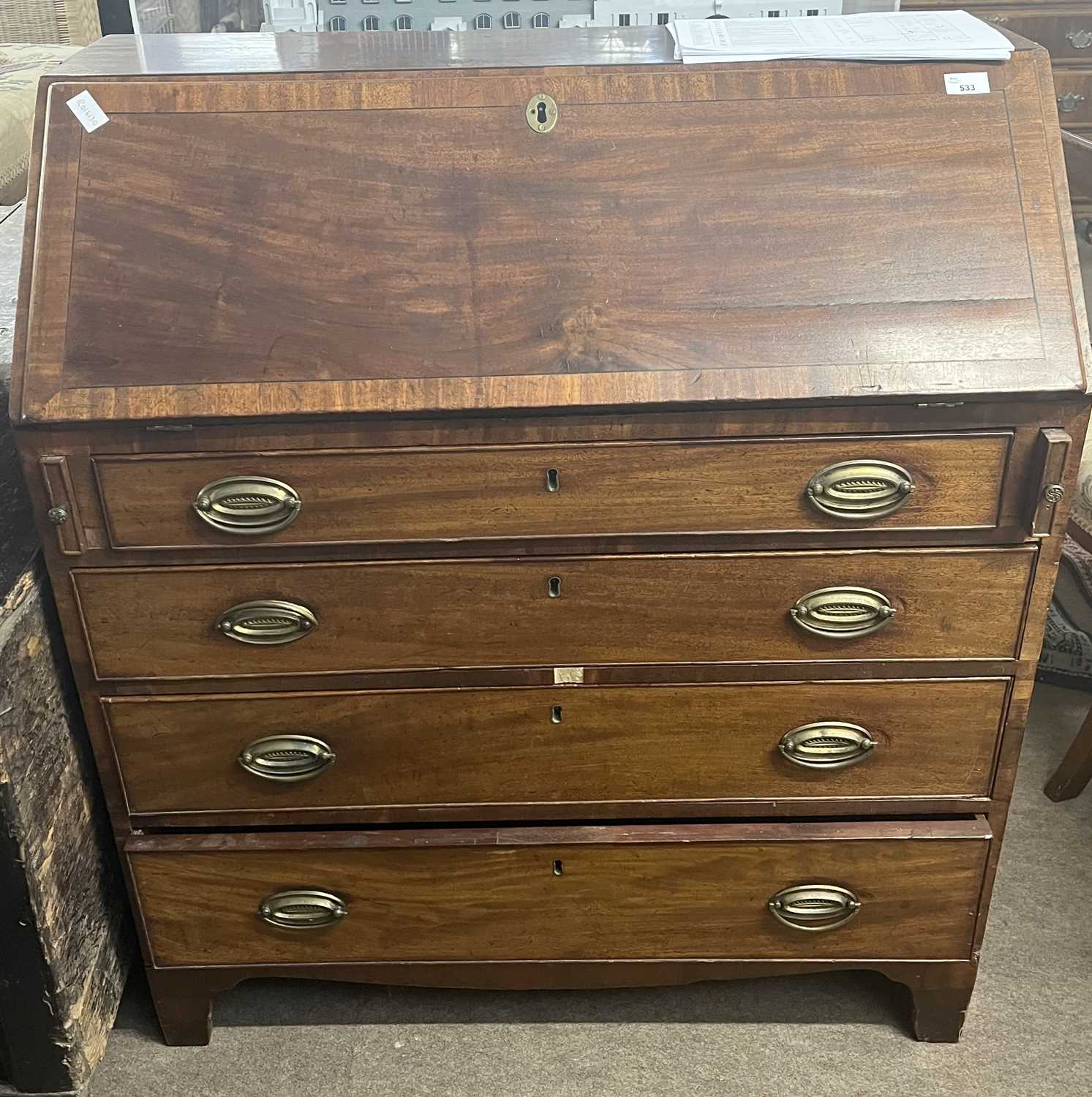 A late Georgian mahogany bureau of typical form with full front, fitted interior and four