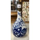 A Chinese porcelain vase, baluster body with blue and white decoration and metal repair to rim