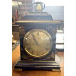 A small early 20th Century chinoiserie decorated mantel clock fitted with a brass French movement,