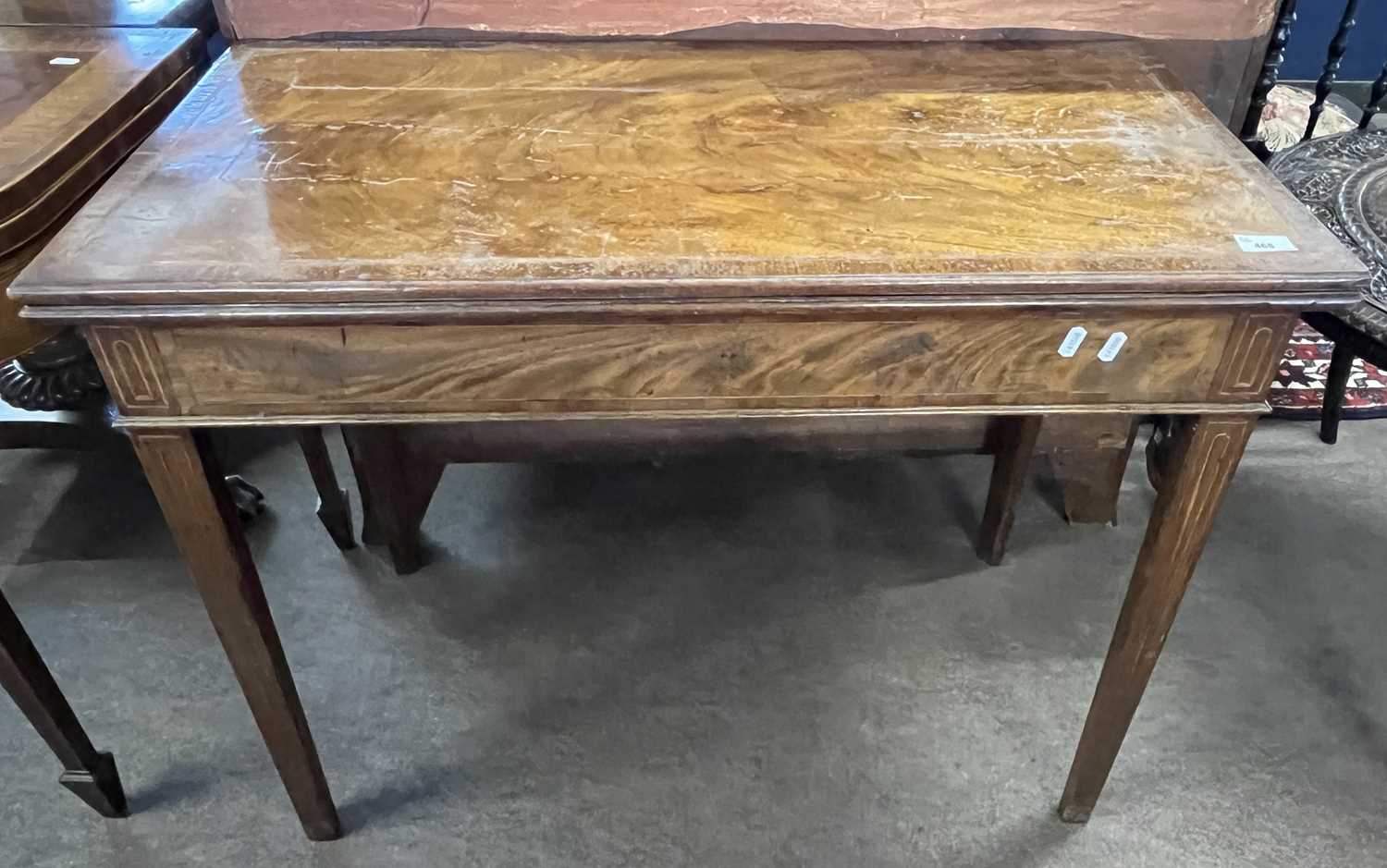 A Georgian mahogany and inlaid tea table of hinged rectangular form set on tapering legs, 92cm wide