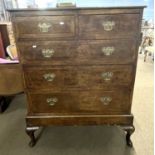 A Georgian and later walnut chest on stand with two short over three long drawers raised on a