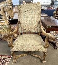A reproduction French late 20th Century reproduction armchair with carved scrolled arms, X formed