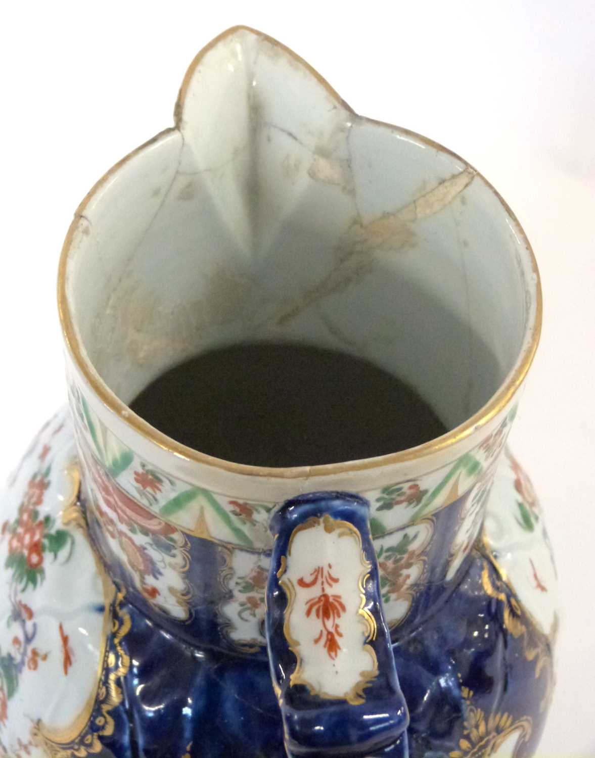 An 18th Century Worcester mask jug with blue ground with panels of Kakiemon style decoration (broken - Image 4 of 6