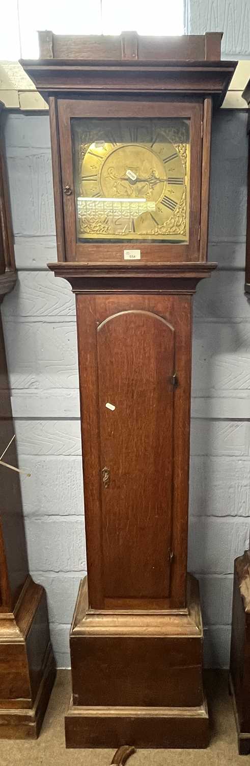 A Georgian brass faced long case clock, the face with pierced spoundrels, single hand to a brass