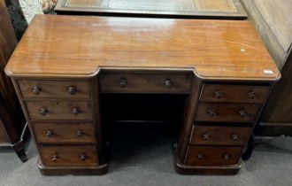 A Victorian mahogany twin pedestal desk or dressing table fitted with nine drawers with turned