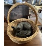 Bronzed resin model of a sleeping fox presented in a wicker basket, fox approx 30cm wide